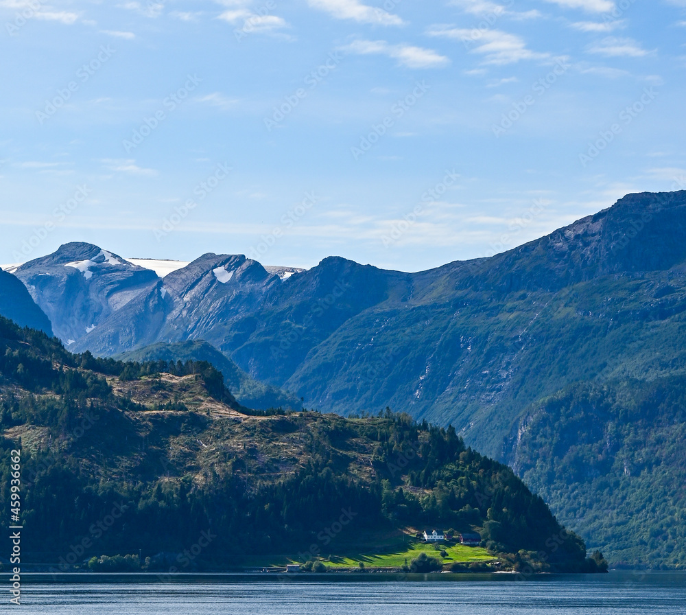 Snowy mountain tops in front of a fjord in Norway