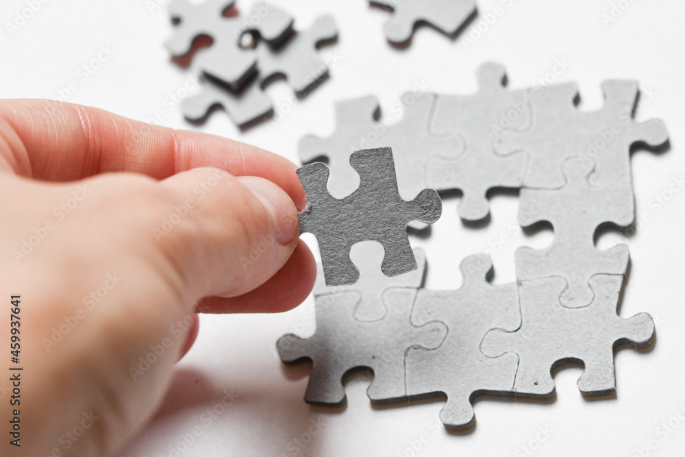 Person adding last piece of jigsaw puzzle Person adding last piece of jigsaw puzzle