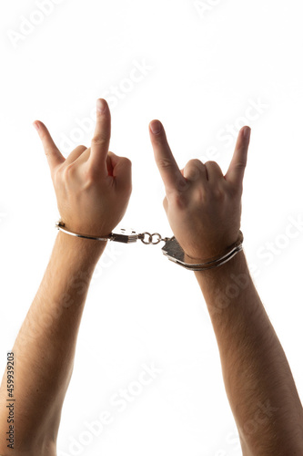 Handcuffed hands isolated on white background.