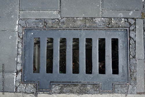 Wallpaper Mural Grille of the drainage system on the pedestrian sidewalk.              Torontodigital.ca