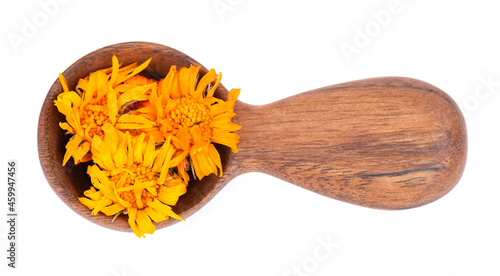 Dried calendula flowers in wooden spoon, isolated on white background. Petals of Calendula officinalis. Medicinal herbs. Top view.