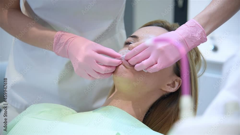 Dentist Puts Oral Ring On Patient's Mouth. Healthcare And Stomatology Concept Dentist Puts Oral Ring On Patient's Mouth. Healthcare And Stomatology Concept