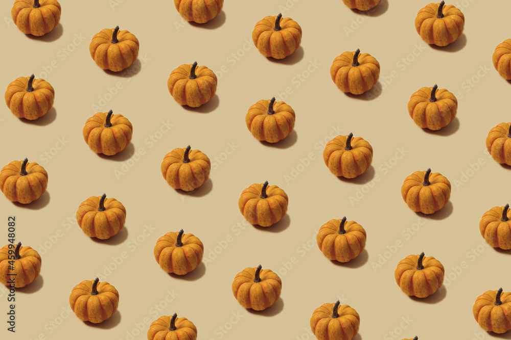 Autumn pattern in yellow and orange colour. Halloween mini pumpkins minimal background. Creative layout.