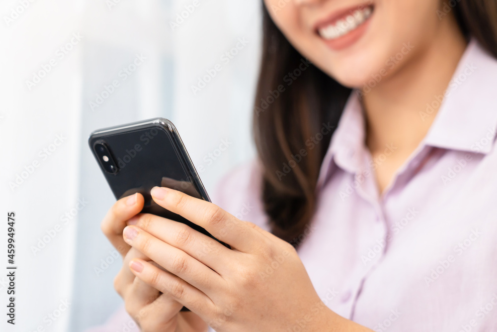 Young smiling woman using and typing smartphone. Young smiling woman using and typing smartphone.