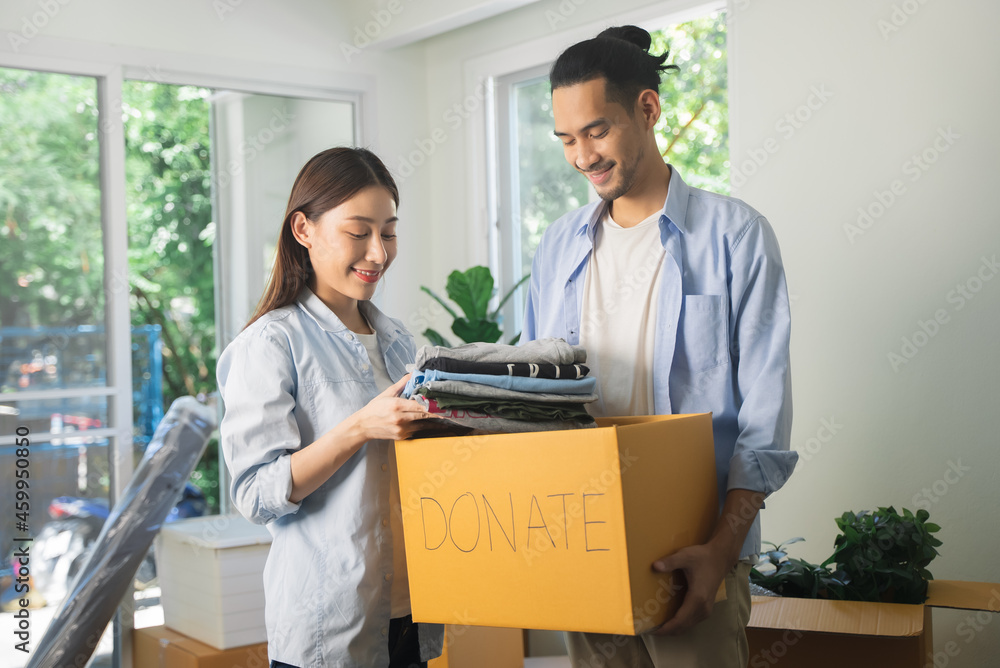 Group of people preparing clothes in donation box preparing to give to another people Group of people preparing clothes in donation box preparing to give to another people