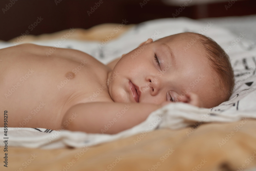 Restful baby peacefully sleeping in soft and cosy bed Restful baby peacefully sleeping in soft and cosy bed