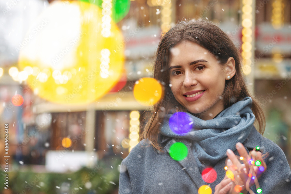 Merry lady walking with bokeh light during the snowfall Merry lady walking with bokeh light during the snowfall