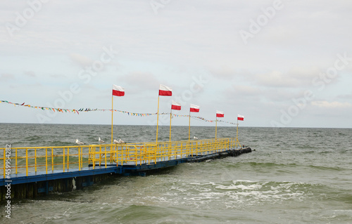 Polish flag on the pier on the Baltic Sea
