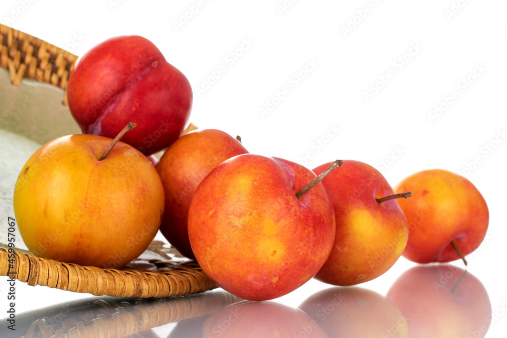 Several juicy organic yellow-red plums on a ceramic plate, close-up, isolated on white. Several juicy organic yellow-red plums on a ceramic plate, close-up, isolated on white.