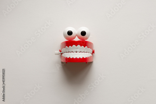 Slika na platnu Eyes and teeth toy on white background