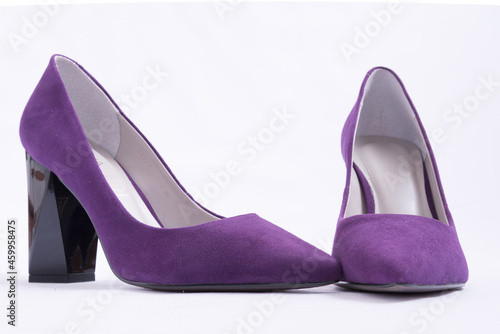 A pair of purple high-heeled shoes. Suede women's elegant shoes on a white background