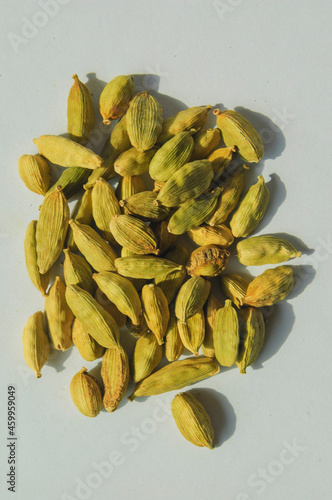 Cardamom grains on a pile isolated with white background photo