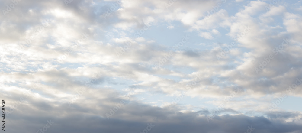 Gray-white majestic clouds on soft blue sky	
