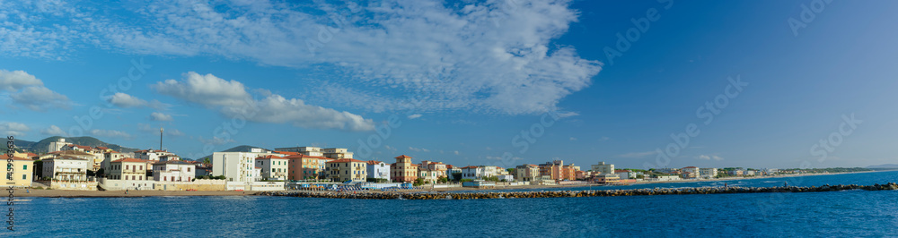 Panorama of the city of San Vincenzo, seen from the sea. Blue sky and clouds. Livorno, Tuscany, Italy