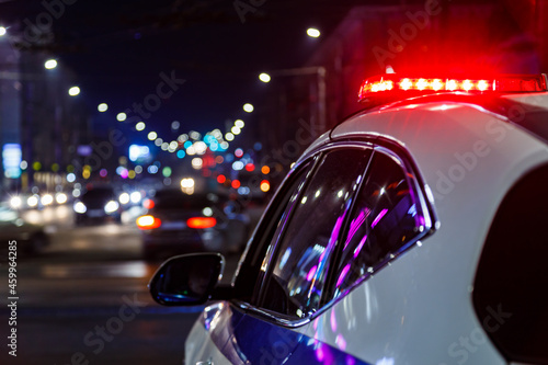 Fényképezés police car lights in night city with selective focus and bokeh
