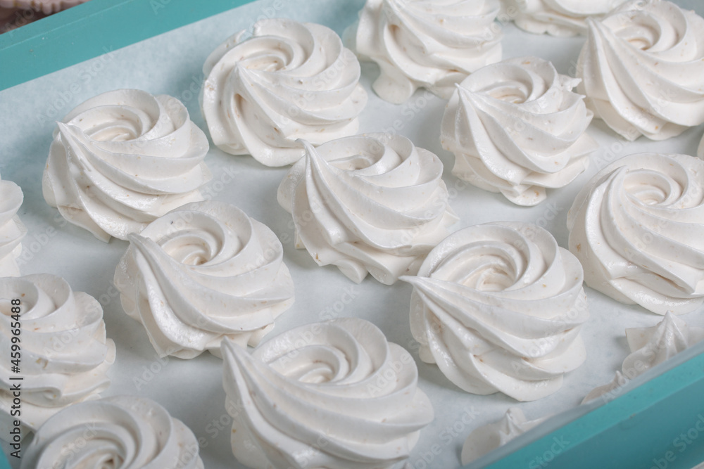 Homemade marshmallows of various shapes and colors are laid out on trays. Stabilization of Zephyr before packaging. Homemade marshmallows of various shapes and colors are laid out on trays. Stabilization of Zephyr before packaging.