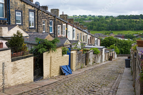 A steep terrace of traditional 19th century millworkers' cottages, seen from the back lane between Basil Street and Colne Lane: Colne, Lancashire, UK photo