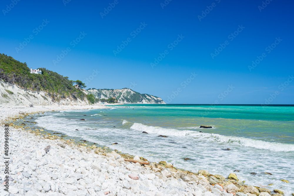 The beach of Portonovo unique bay in Conero natural park dramatic coast headland rock cliff adriatic sea Italy turquoise transparent water The beach of Portonovo unique bay in Conero natural park dramatic coast headland rock cliff adriatic sea Italy turquoise transparent water