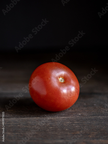 red tomato on a wooden table