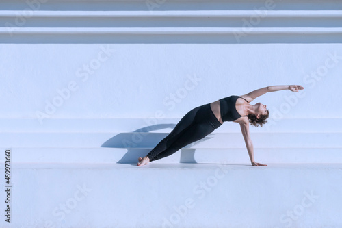 Woman on the floor in yoga pilates pose outdoors