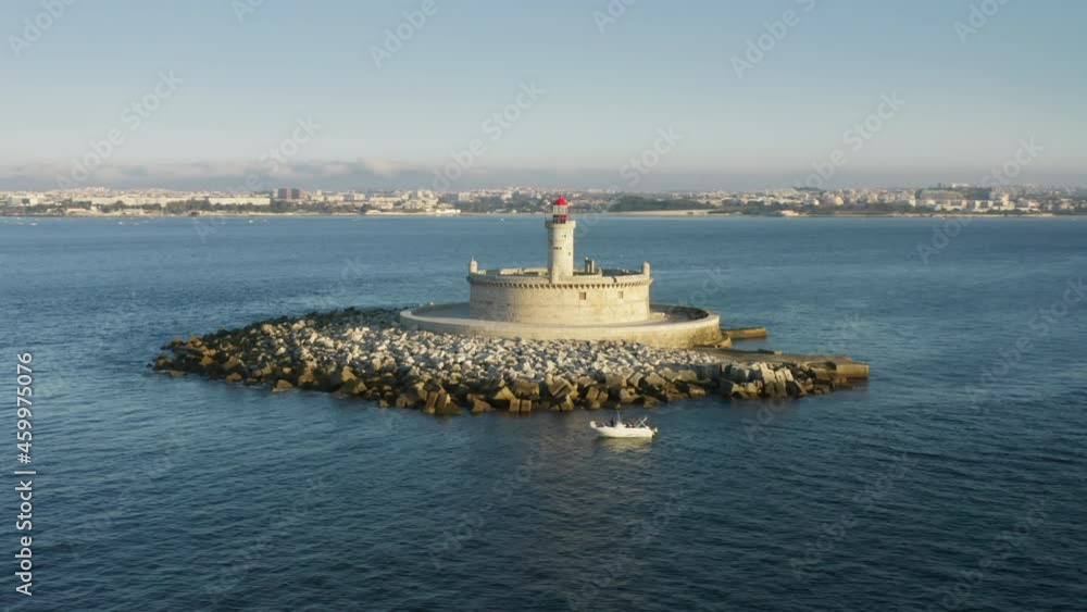 Lisbon. Portugal. Beautiful lighthouse on small islet as seen from above. Aerial footage of offshore beacon within the Atlantic Ocean. High quality 4k footage Lisbon. Portugal. Beautiful lighthouse on small islet as seen from above. Aerial footage of offshore beacon within the Atlantic Ocean. High quality 4k footage
