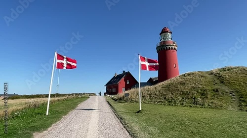 The Bovbjerg Lighthouse, with waving danish flags in slowmotion, Bovbjerg, Denmark. photo