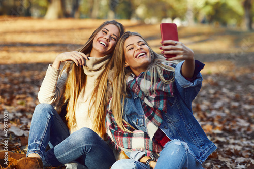 Two young women making selfie in the park