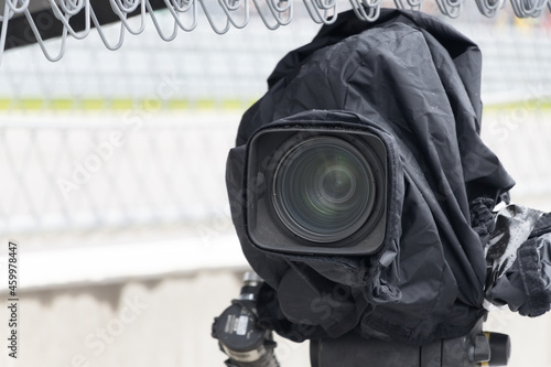 TV camera broadcasting live a race at motor racing track.