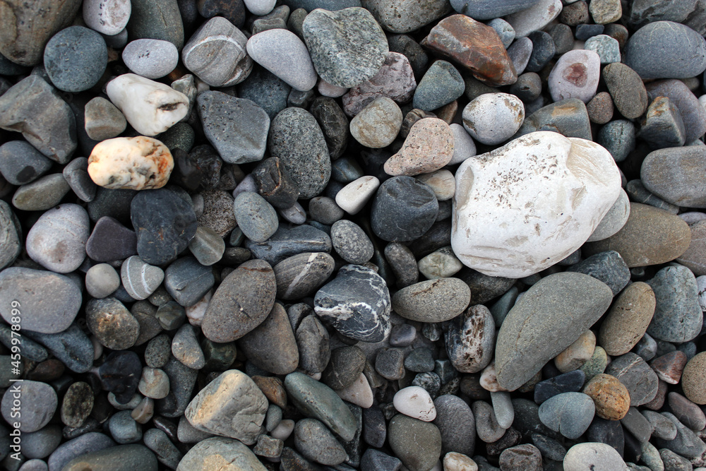 Sea coast, pebble beach background. Large beautiful stones for the background. The concept of tranquility. Sea coast, pebble beach background. Large beautiful stones for the background. The concept of tranquility.