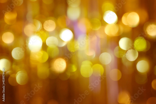 Abstract Christmas blurred background of golden Bokeh glitter