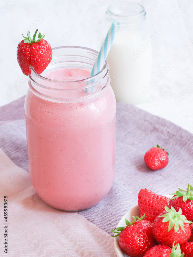Fresh healthy strawberries smoothie with natural yogurt in a jar, health benefit for diet people concept Fresh healthy strawberries smoothie with natural yogurt in a jar, health benefit for diet people concept