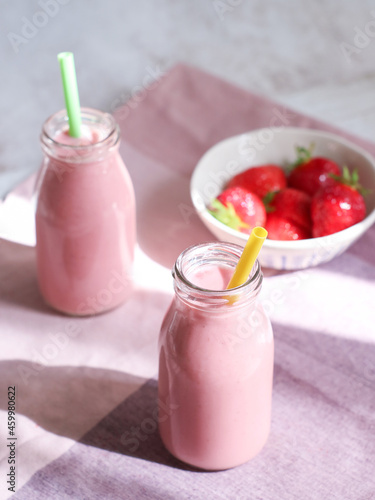 Bottles of fresh strawberries natural yogurt smoothie, a healthy immunity treat and for people who following a diet 