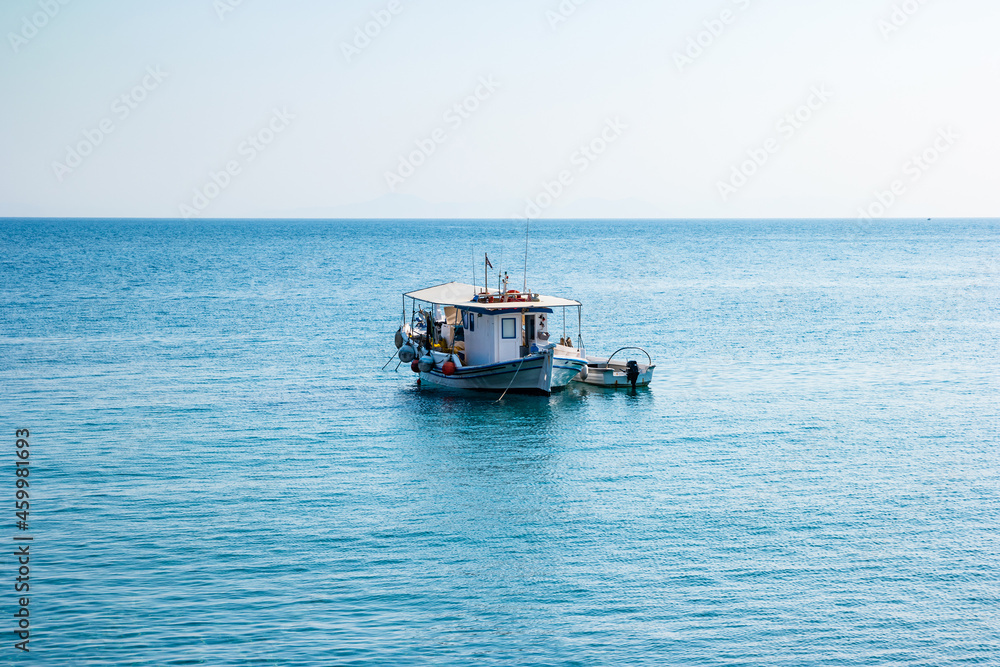 Boats in port at small fishing village of Kamiros Skala. Rhodes, Greece