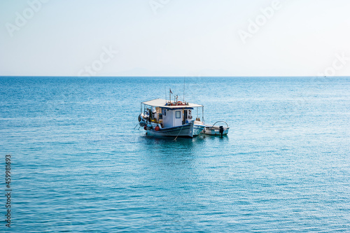 Boats in port at small fishing village of Kamiros Skala. Rhodes, Greece © perekotypole