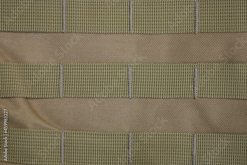 Bild auf Leinwand green texture of fabric from a part of a backpack with sewn stripes