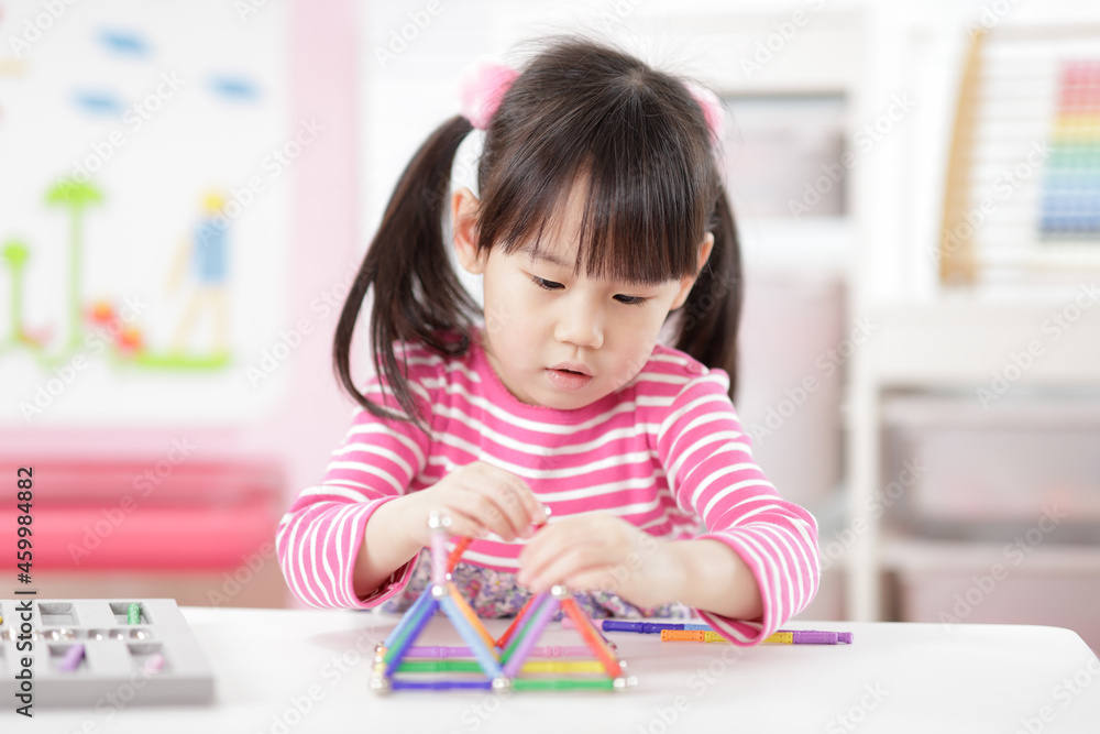 young girl playing creative 3d shape toy for homeschooling young girl playing creative 3d shape toy for homeschooling