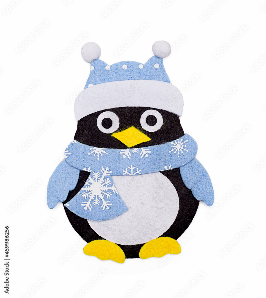 Christmas tree toy made of felt - a penguin in a hat, isolated on a white background. Christmas tree toy made of felt - a penguin in a hat, isolated on a white background.