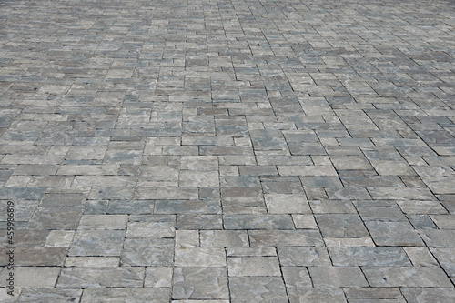 Full frame view with diminishing perspective of cement brick pavement