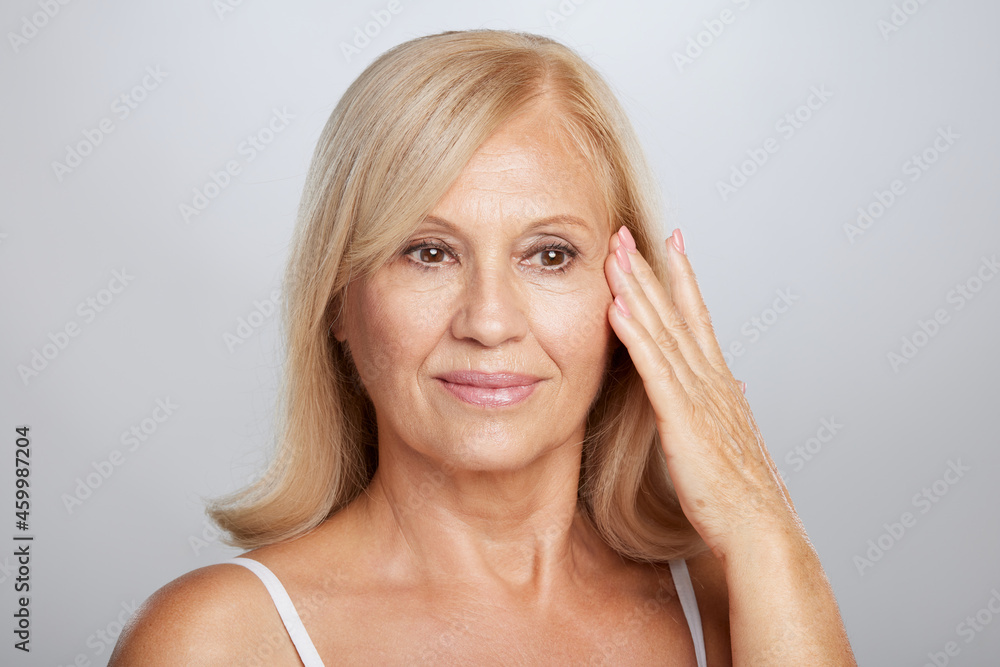 Close up of a beautiful senior lady touching her soft wrinkled skin. Beauty photography Close up of a beautiful senior lady touching her soft wrinkled skin. Beauty photography