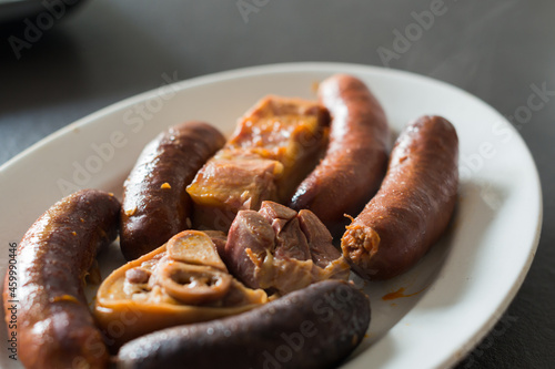 Close up of compango, side dish with meat, chorizo, jam and blood sausages to add the traditional meal in Asturias, fabada. Asturias gastronomy. Spain photo