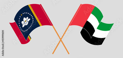 Crossed and waving flags of The State of Mississippi and the United Arab Emirates