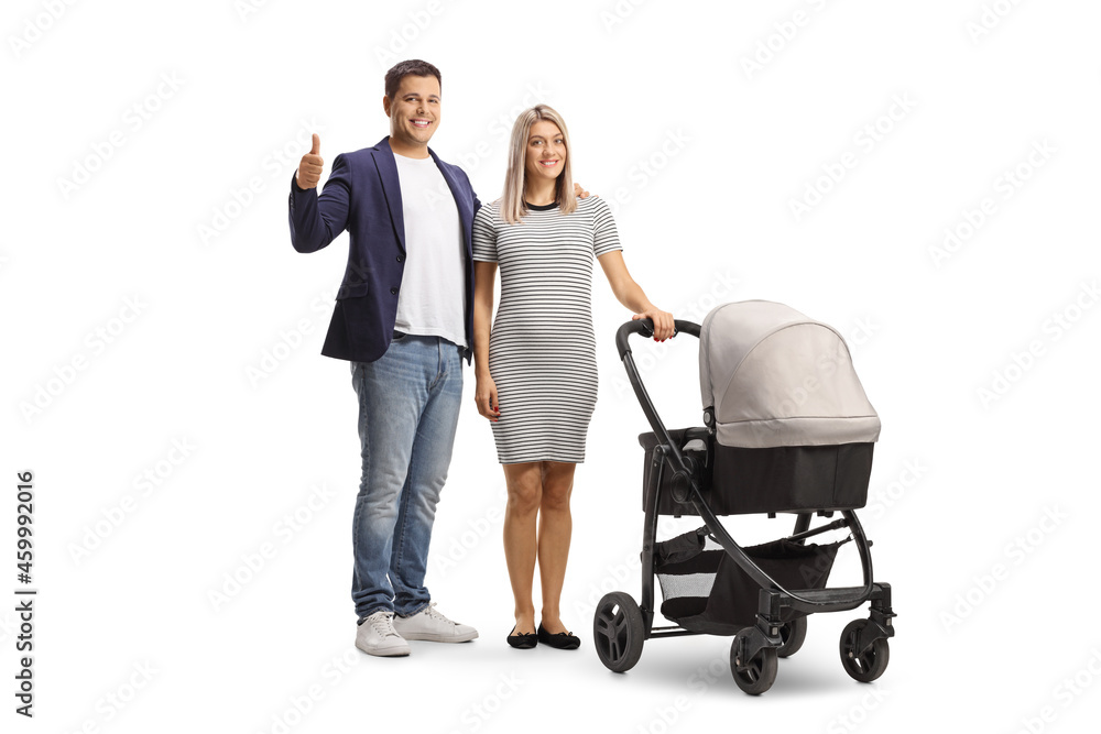 Full length portrait of a father gesturing a thumb up sign and a mother with a baby stroller Full length portrait of a father gesturing a thumb up sign and a mother with a baby stroller