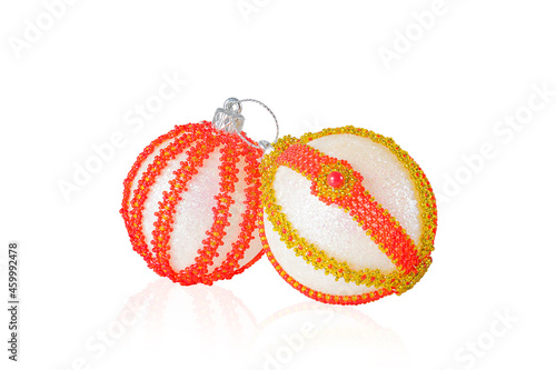 Two Christmas balls decorated with beads on a white background