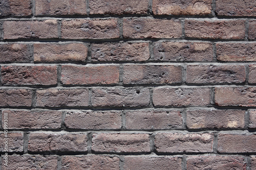 Full frame close-up view of an old brick building wall
