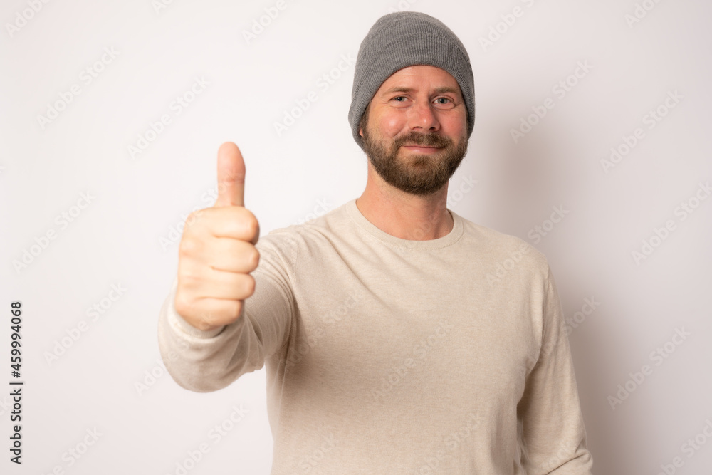 Young handsome caucasian man wearing casual clothes and wool cap smiling happy. Young handsome caucasian man wearing casual clothes and wool cap smiling happy.