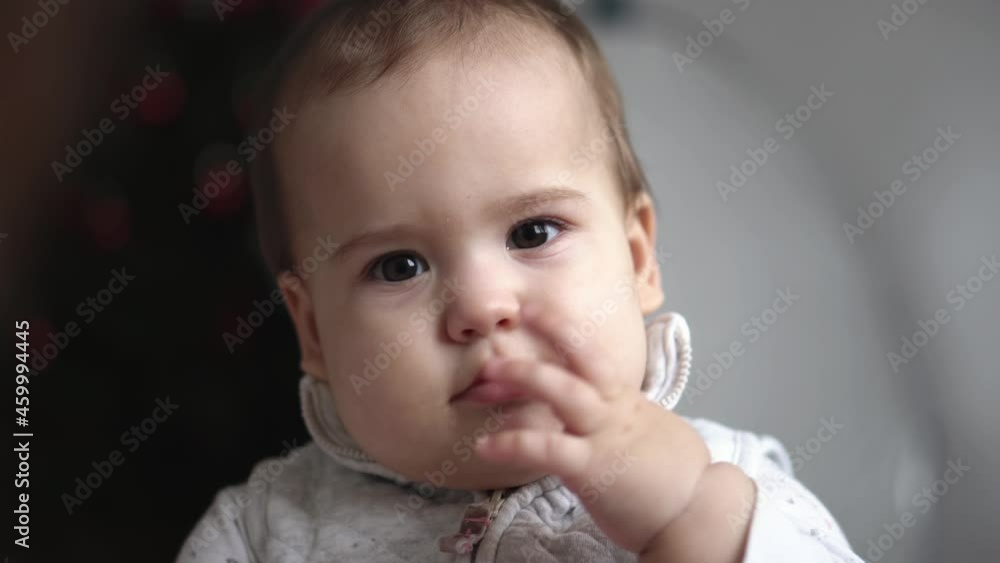 Infant, motherhood, happiness concepts - close up Portrait of adorable little child kid baby boy girl have positive emotion. Cute toddler posing look at camera laugh enjoy happy Wiggle Finger on Lips Infant, motherhood, happiness concepts - close up Portrait of adorable little child kid baby boy girl have positive emotion. Cute toddler posing look at camera laugh enjoy happy Wiggle Finger on Lips