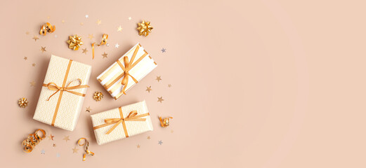 Christmas background with gift boxes wrapped in golden colored paper. Xristmas celebration, preparation for winter holidays. Festive mockup, top view, flat lay