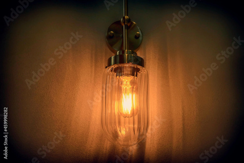 The wall lamp is on fire at night.