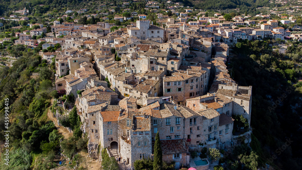 Aerial view of the curved city plan of Tourrettes sur Loup in the mountains above Nice on the French Riviera, France - Old stone houses nestled on a belvedere in Provence