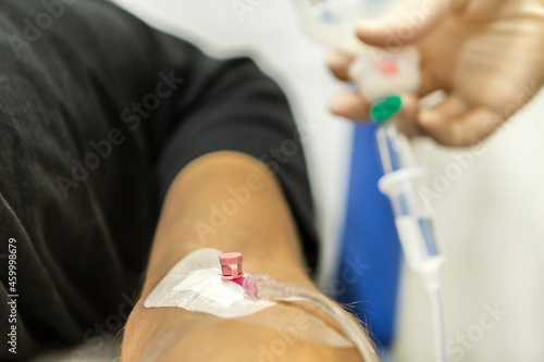 A nurse placing an infusion to a patient